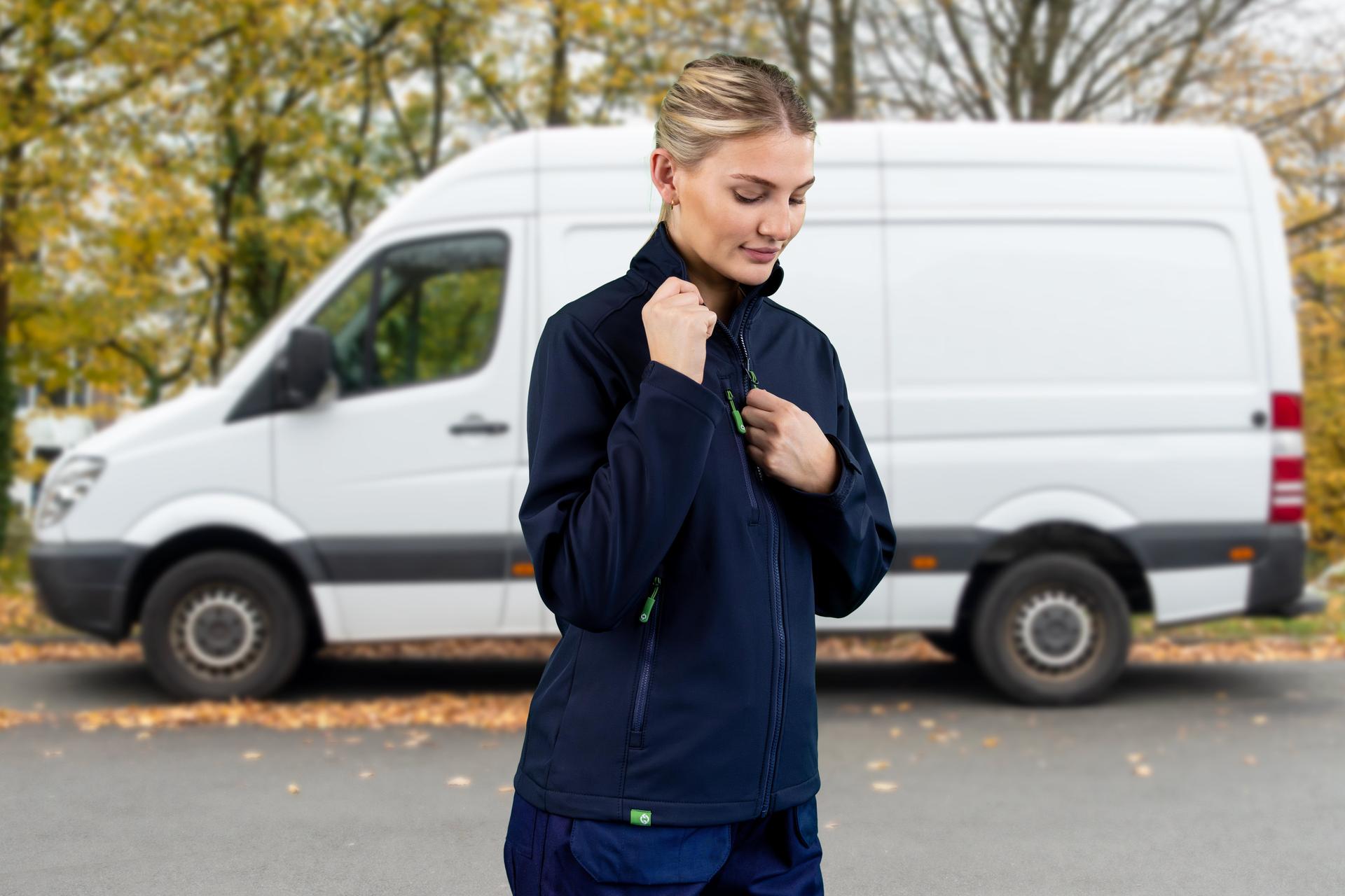 Woman wearing Arco Responsible Choice jacket stood in front of a white van